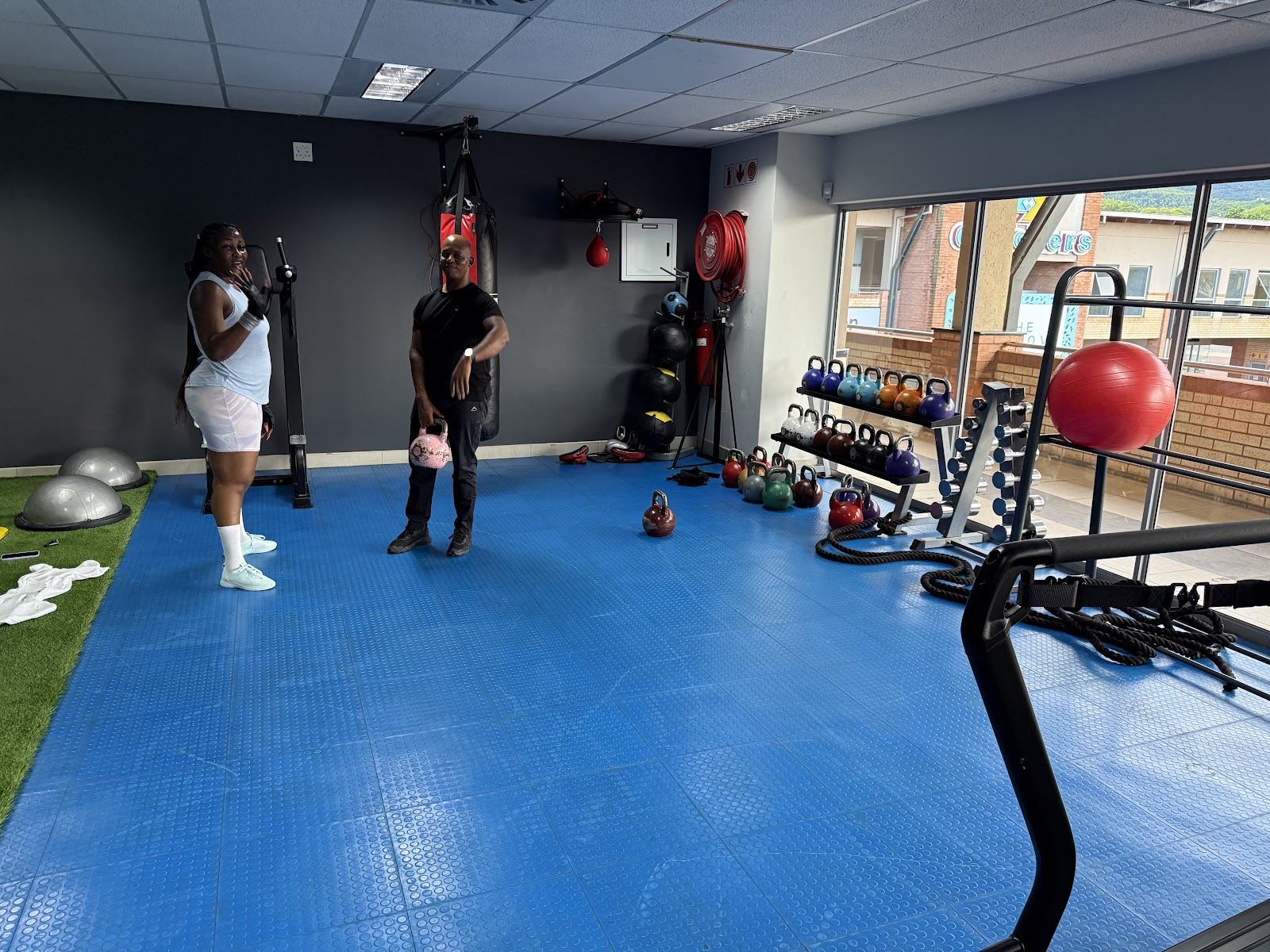 Functional training area with kettlebells and battle ropes